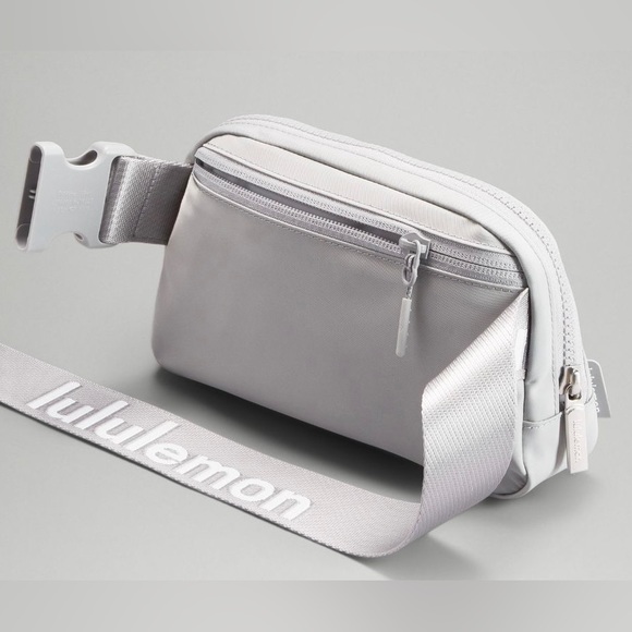 lululemon athletica Handbags - NWT Lululemon Wordmark Everywhere Belt Bag Silver/ White Lettering